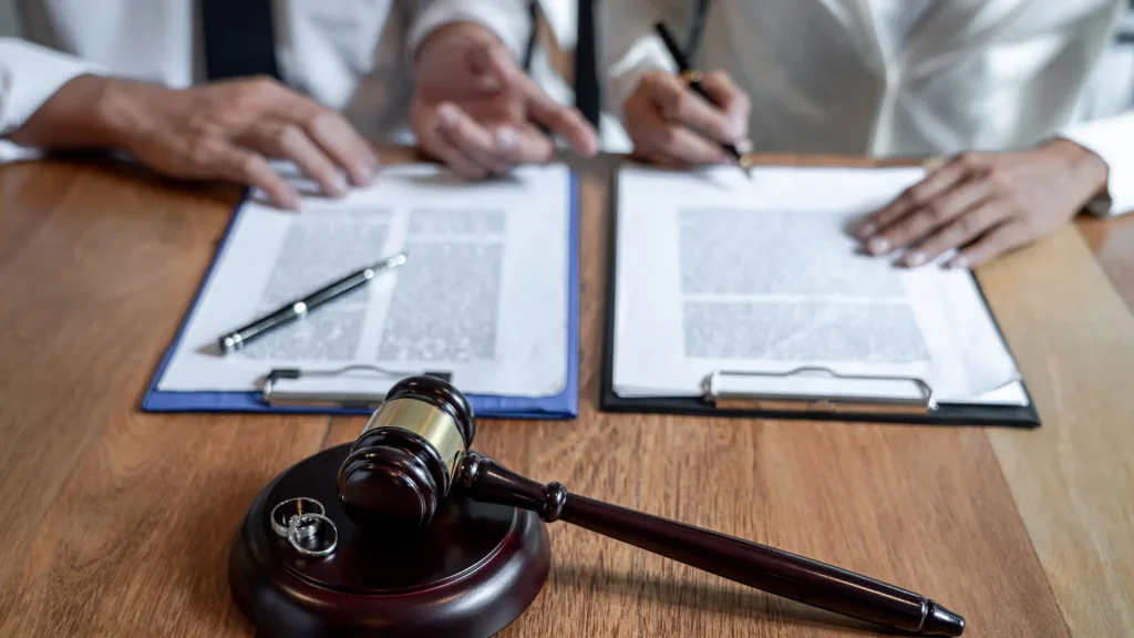 Legal documents with a gavel and pen on a table during a discussion